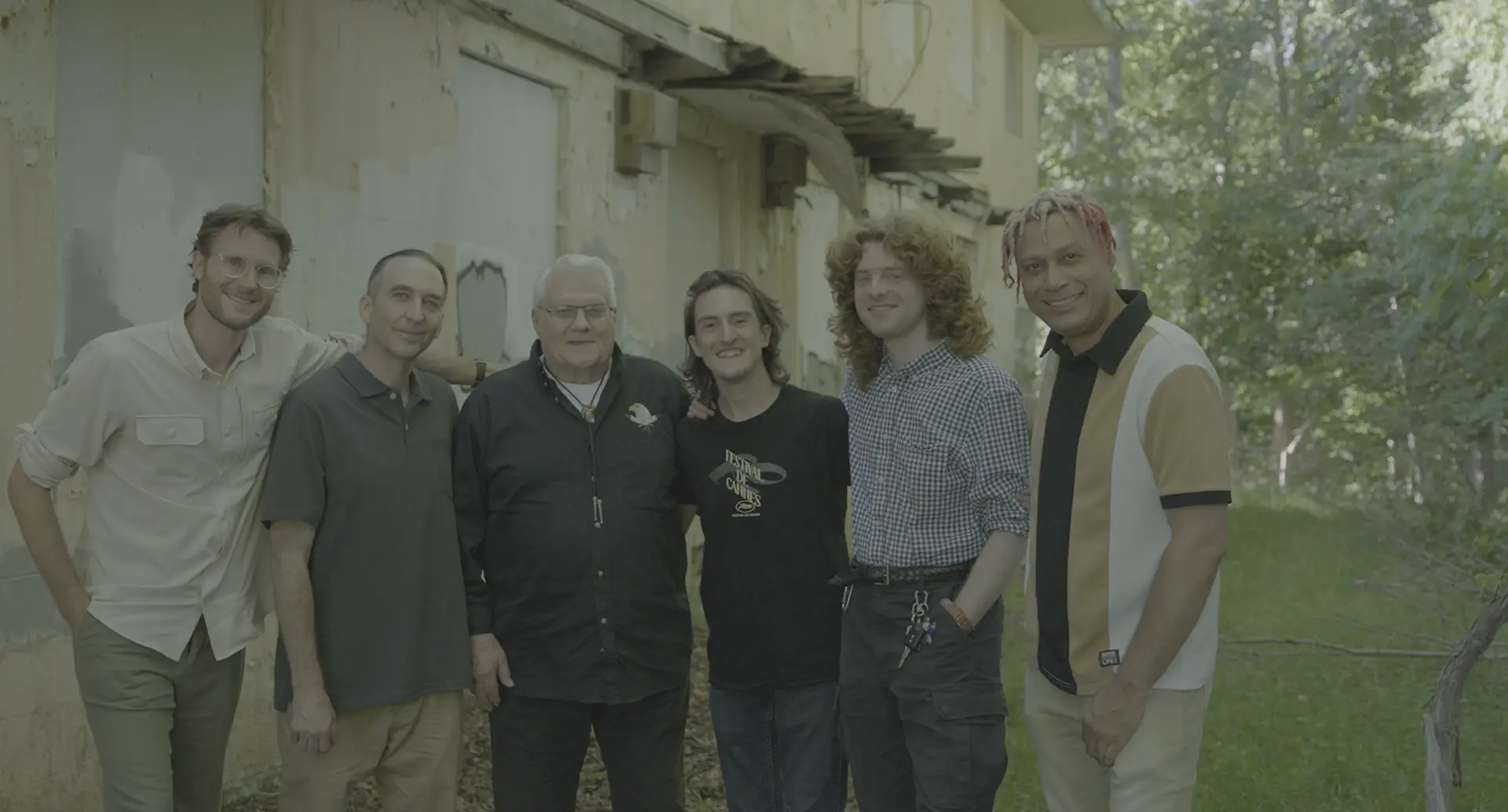 Cast and crew of Montauk: Off the Record standing together in front of a Camp Hero bunker.
